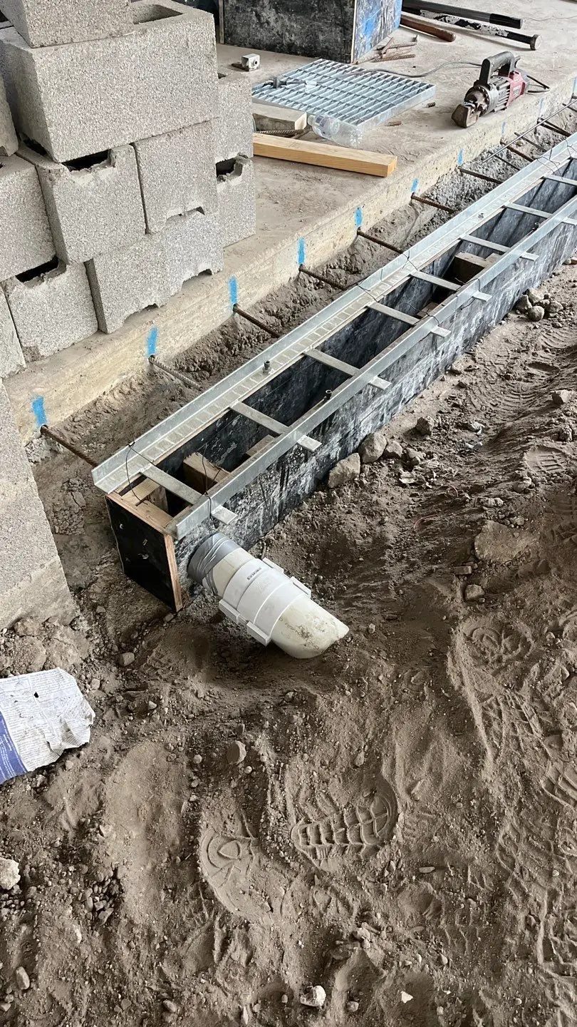 Strip drain formwork with outlet boxed and connected before pouring
