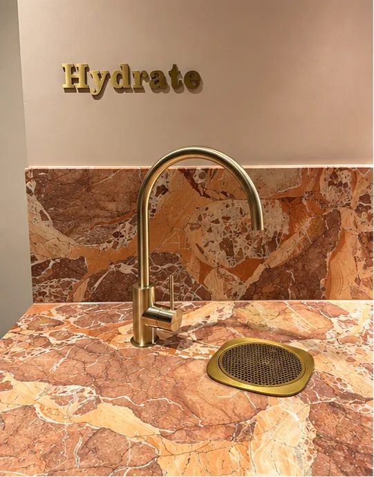 Hydration station with stone benchtop, brass tapware and concealed greywater pump