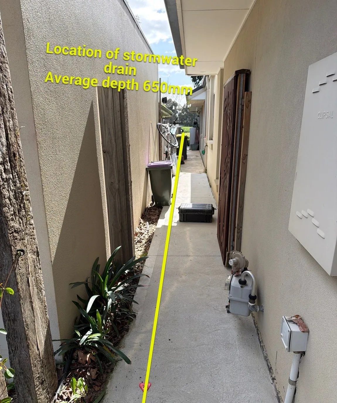Site photo from a Normac report, marked up with the stormwater drain run and its average depth