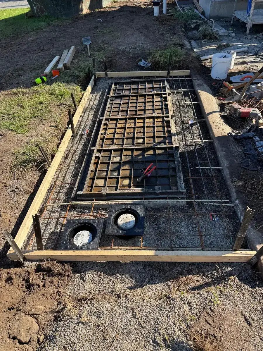 Steel reinforcement and formwork over an in-ground tank before the concrete pour
