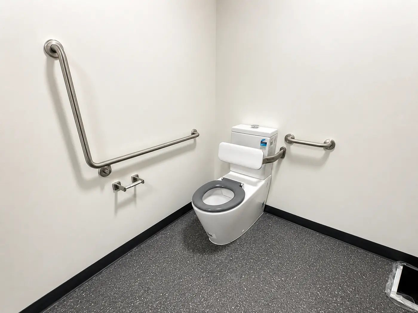 Completed accessible amenity with grab rails and compliant fixtures